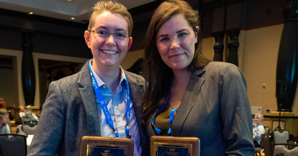 Image of two smiling women holding their awards