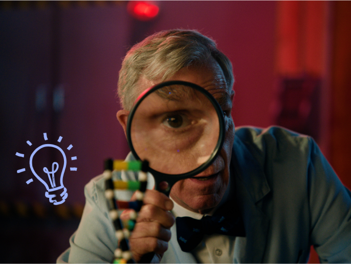 Bill nye looking through magnifying glass
